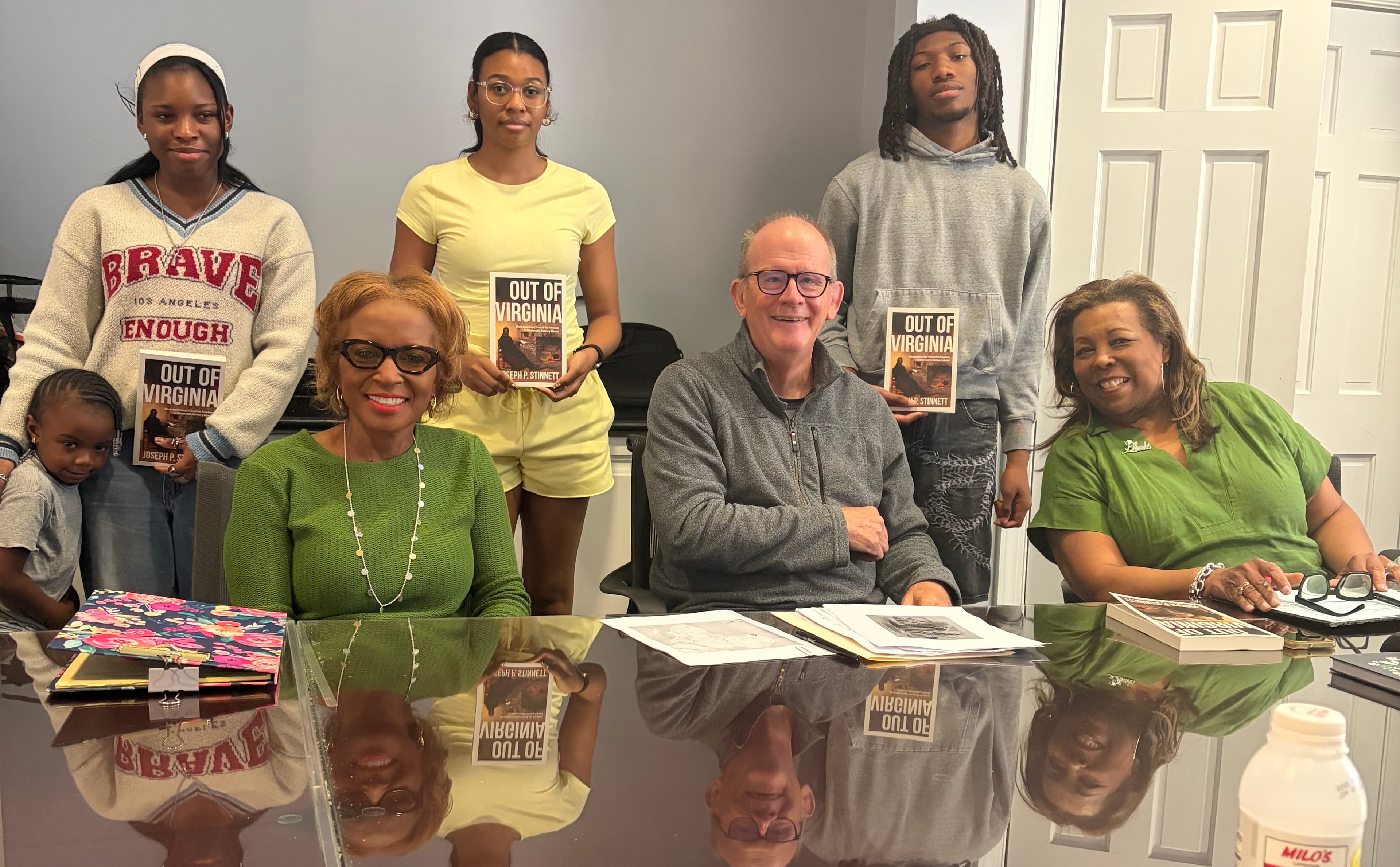 Joseph Stinnett seated with LINKS members and area students at Randolph College, several holding copies of Out of Virginia.